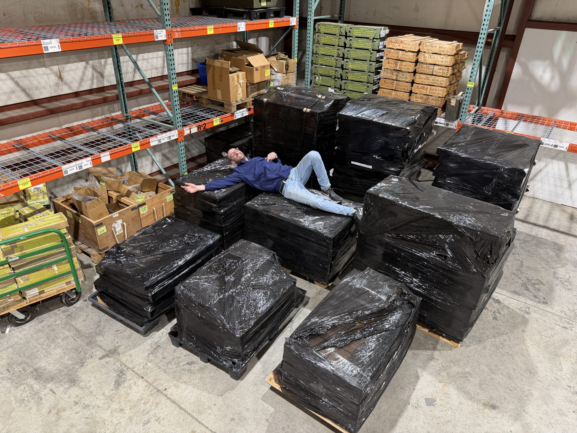 Kris is swimming in a sea of pallets of goodies!